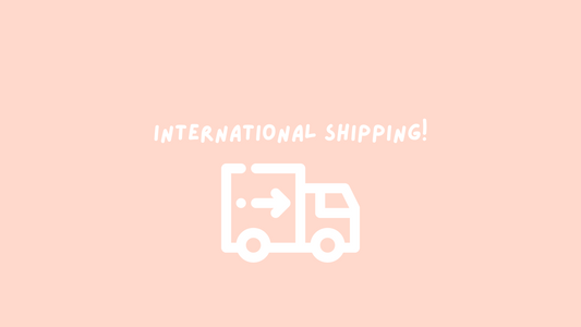 Pink background with white text ‘international shipping’
