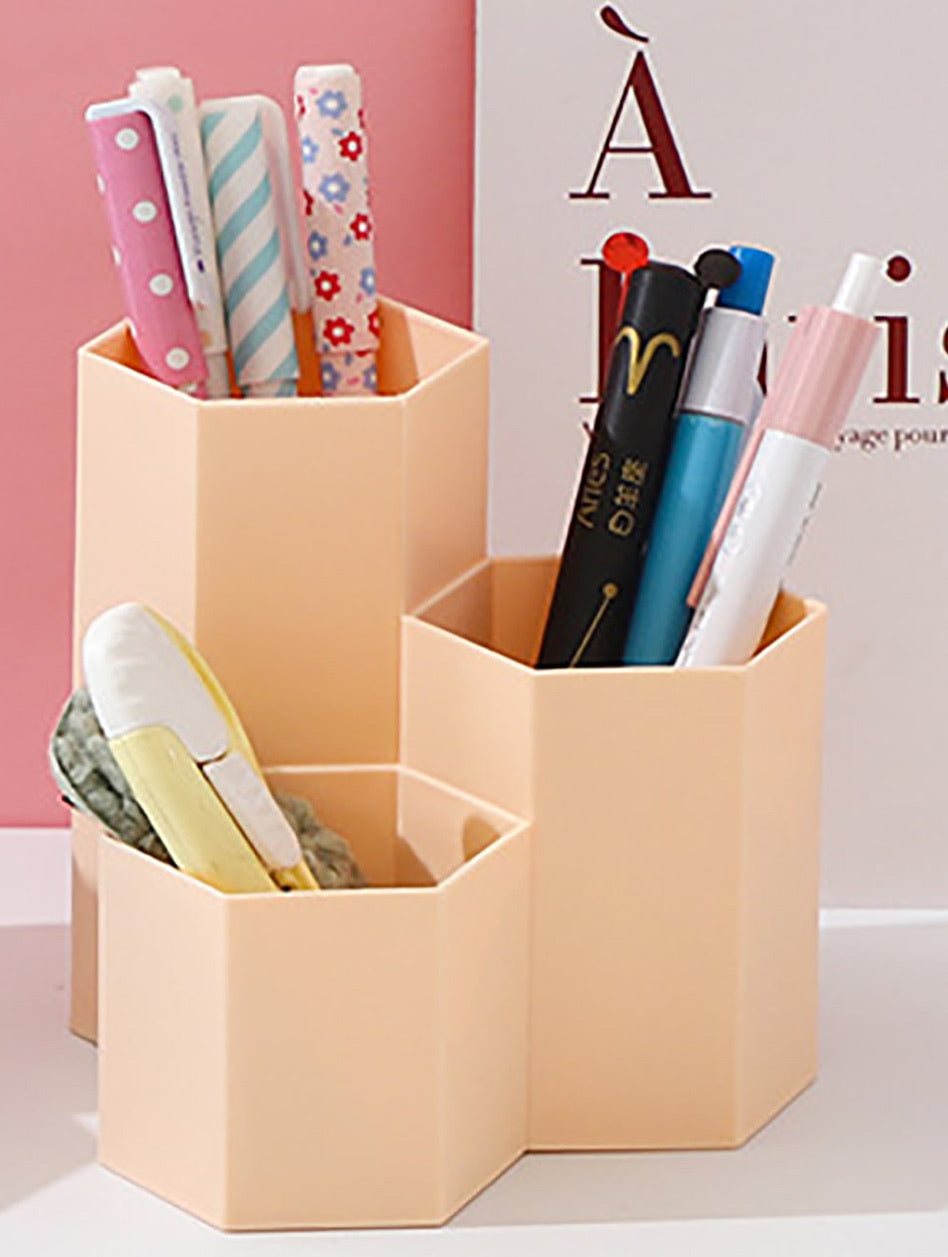 pink hexagon pen pot with 3 compartments each containing pens and eraser